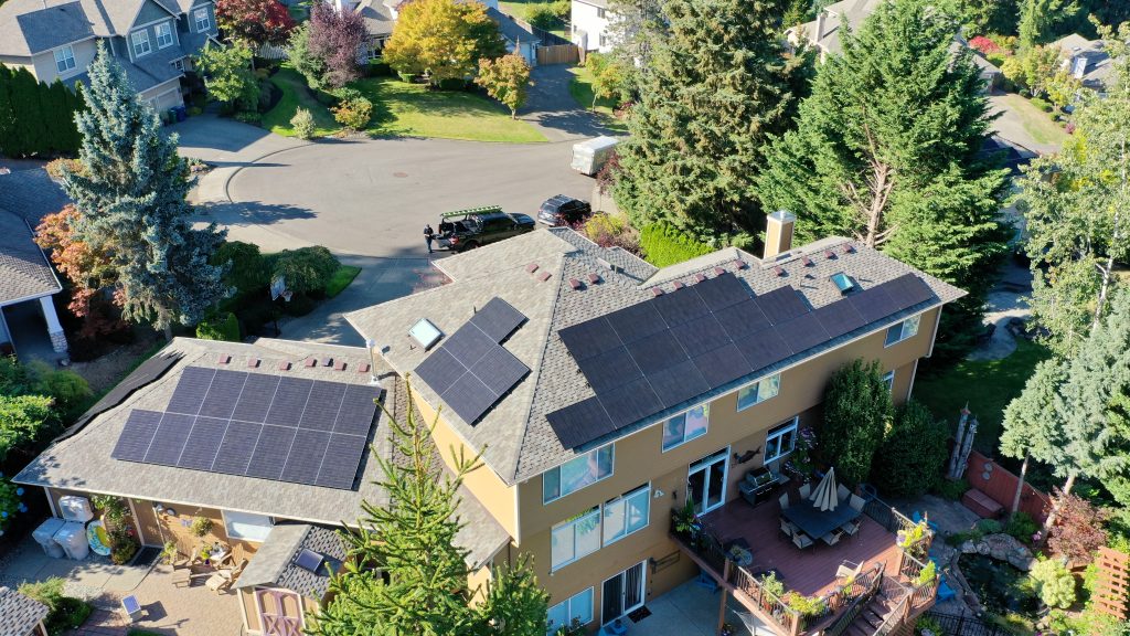 Solar arrays installed alongside new Presidential Shake roofing in Country Gray, photographed from above on this Renton home.