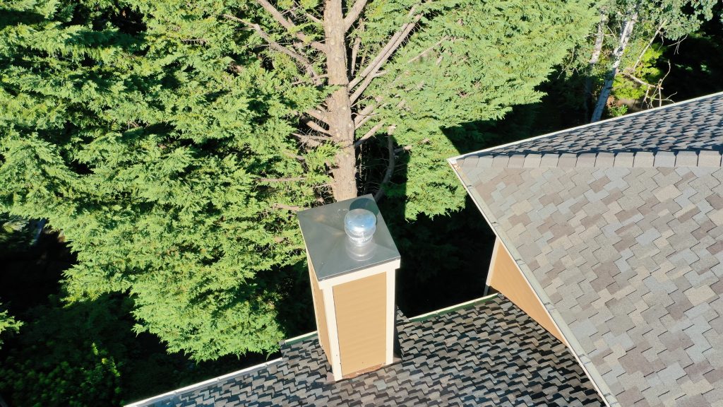 New custom stainless steel chimney chase cap installed by Pinnacle Roofing Professionals on a Renton, WA home.