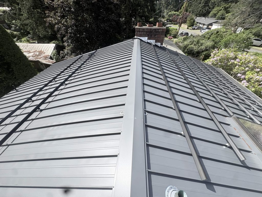 Ridge view of Nu-Ray standing seam metal roof with black solar mounting rails in Shoreline, WA