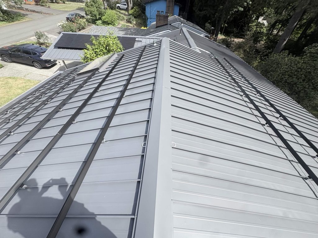 Long black solar rail runs mounted on a Nu-Ray standing seam metal roof in Shoreline, WA