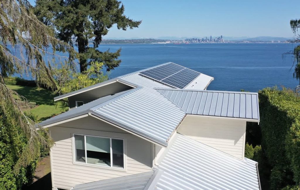 White Nu-Ray Series 2000 standing seam metal roof with solar panels on a waterfront home in Bainbridge Island, WA