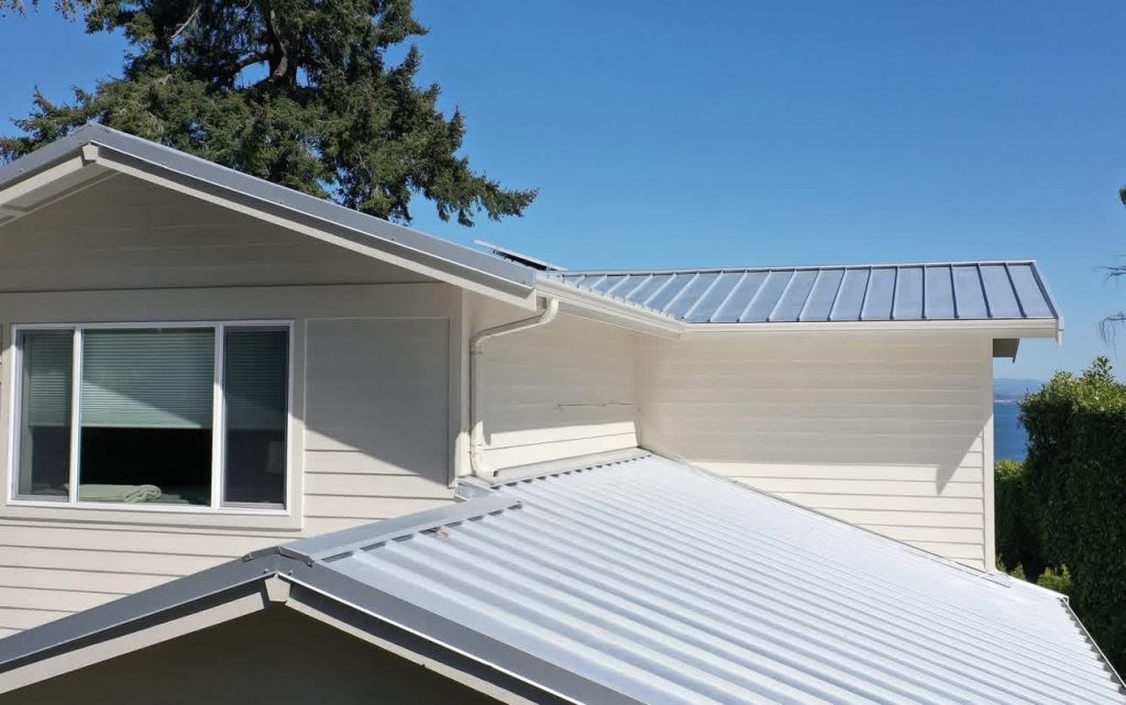 Rear view of white Nu-Ray Series 2000 standing seam metal roof and solar array on a Bainbridge Island, WA home
