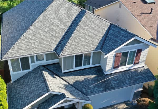 Angled drone view of Sammamish, WA roof replacement showing complex gables, valleys, and crisp white fascia on CertainTeed NorthGate shingles