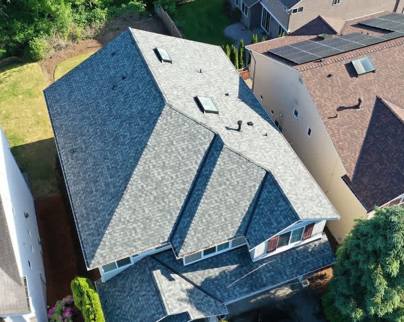 High drone view of completed Sammamish, WA roof replacement with CertainTeed NorthGate shingles, two skylights, and clean white fascia