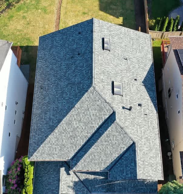 Top-down drone overview of Sammamish, WA residential roof with two in-line CrystaLite skylights, ridges, valleys, and white fascia