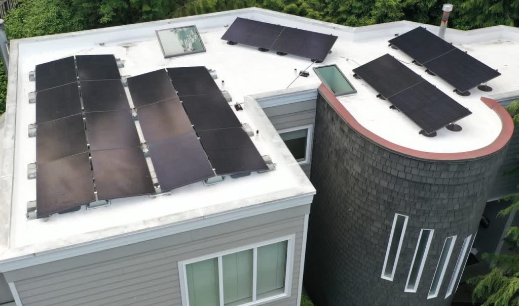 Black Silfab 430W solar panels installed on a flat white roof in the Leschi neighborhood of Seattle