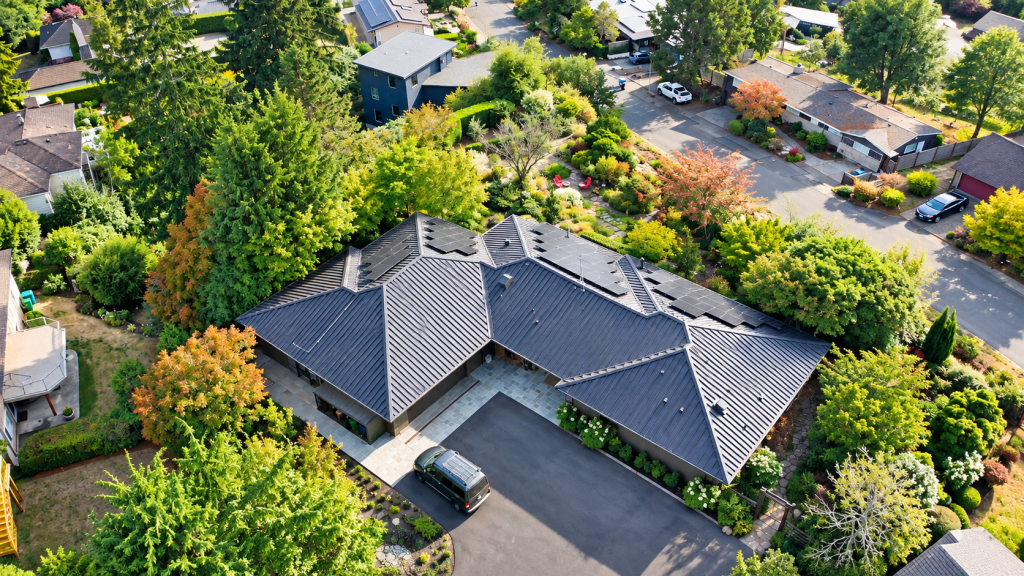 Tree-filled garden surrounding a West Seattle, WA home with a Nu-Ray metal roof and solar energy system