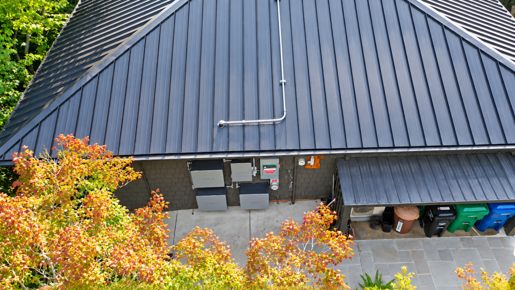 Sunset water view from a West Seattle, WA home with a Nu-Ray metal roof, solar, and battery storage