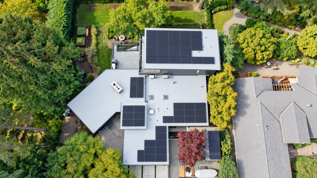 Aerial view of a Bellevue home with a new gray IB PVC roof and Tesla solar panels
