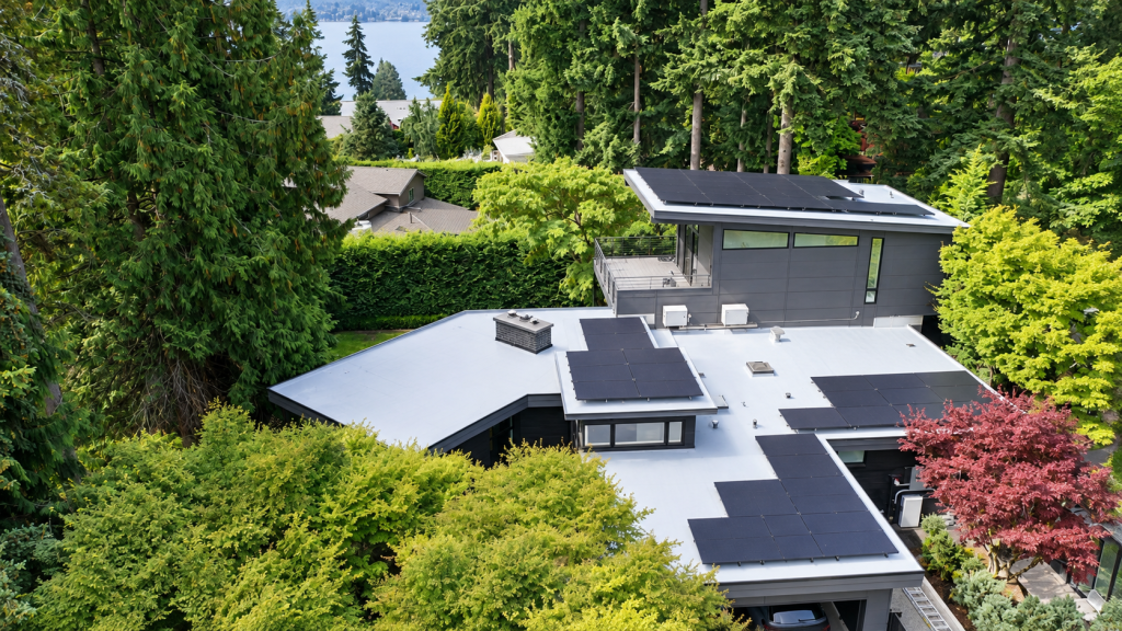 Drone photo of completed IB PVC roof with 24.36 kW Tesla solar array in Bellevue WA