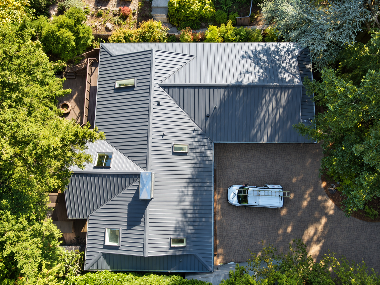 Charcoal gray standing seam metal roof with skylights in Wilburton neighborhood, Bellevue WA — Nu-Ray Metals NRM-2000