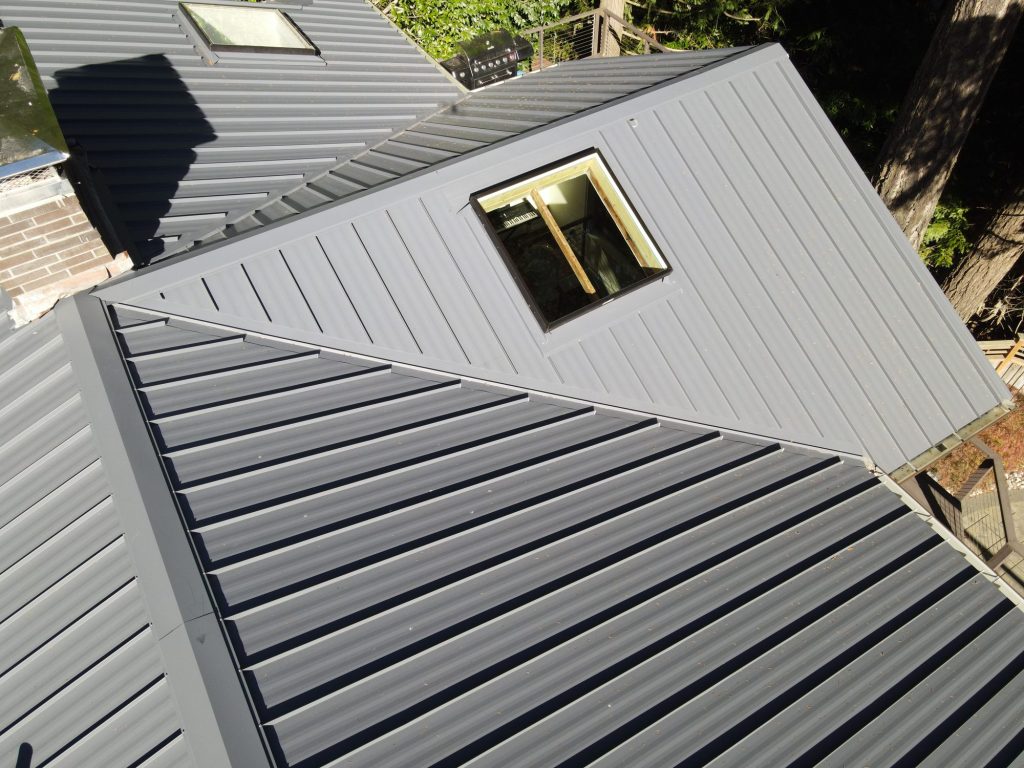 New skylight with framing and flashing detail integrated into a Charcoal Gray standing seam metal roof, Bellevue WA