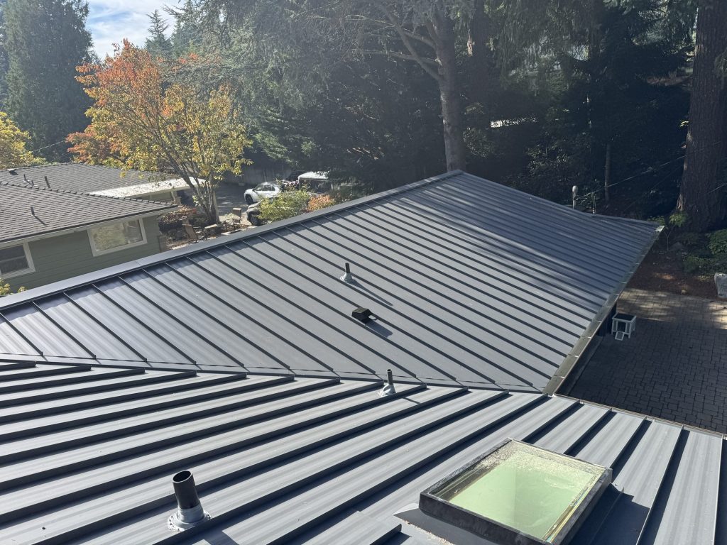 Elevated wide view of the finished Charcoal Gray Nu-Ray NRM-2000 standing seam metal roof in the Wilburton neighborhood, Bellevue WA