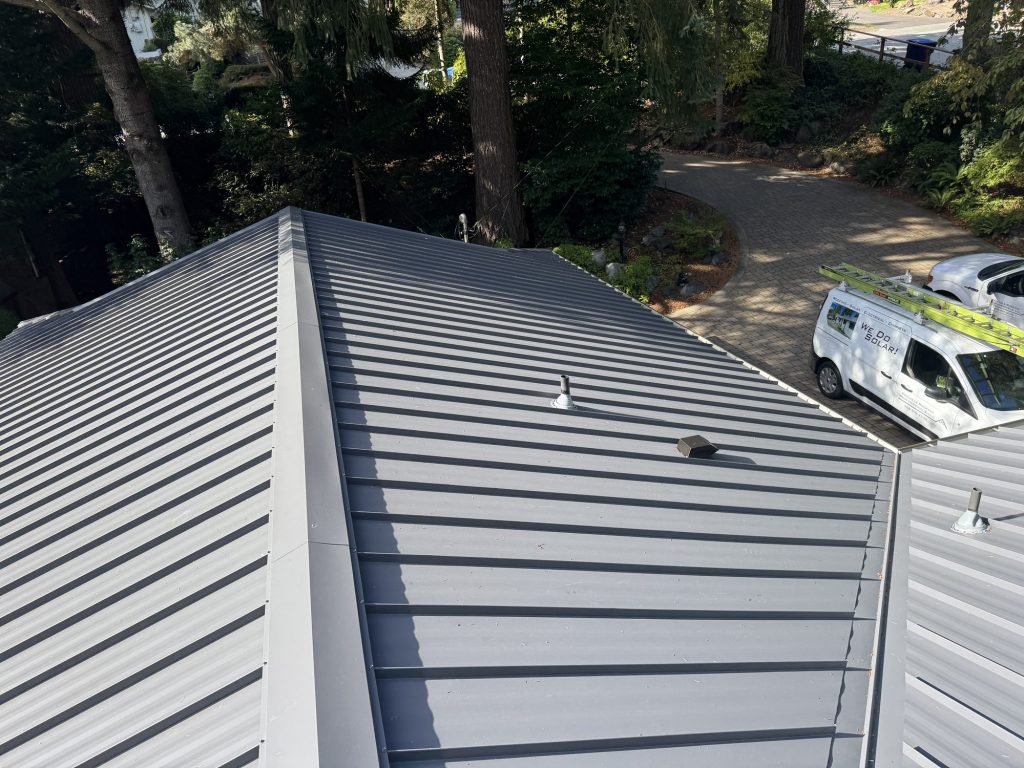 Site-wide view of the full scale of a Nu-Ray NRM-2000 standing seam metal roof replacement in Charcoal Gray, Wilburton neighborhood, Bellevue WA